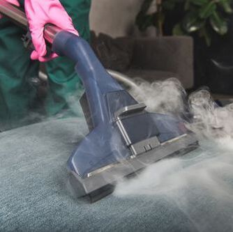 A steam cleaning head working on a sofa in Townsville